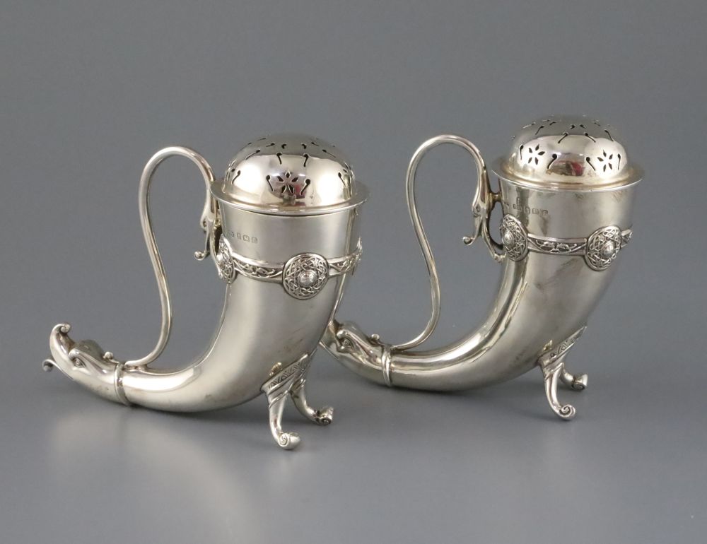 A pair of silver horn-shaped sugar casters with dolphin mask terminals, Birmingham 1929, Henry Matthews,